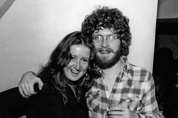 A black-and-white photo of a young Mr. Cuscuna, wearing a plaid shirt, with his arm around Bonnie Raitt, a young woman with long straight hair.