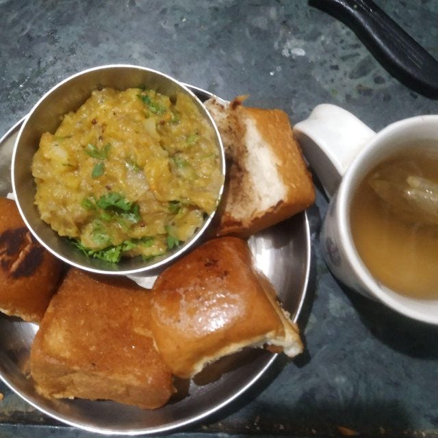 Aloo bhaji in a bowl with four paos surrounding it! Aloo bhaji in a bowl with four paos surrounding it!