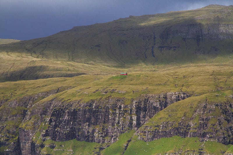 A house on the side of a cliff in the Faroe Islands.