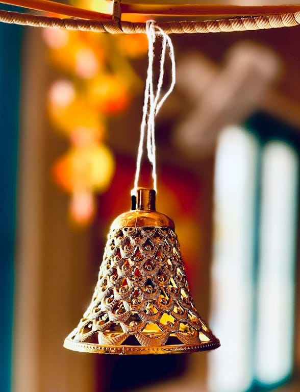 a close up of a bell hanging from a ceiling