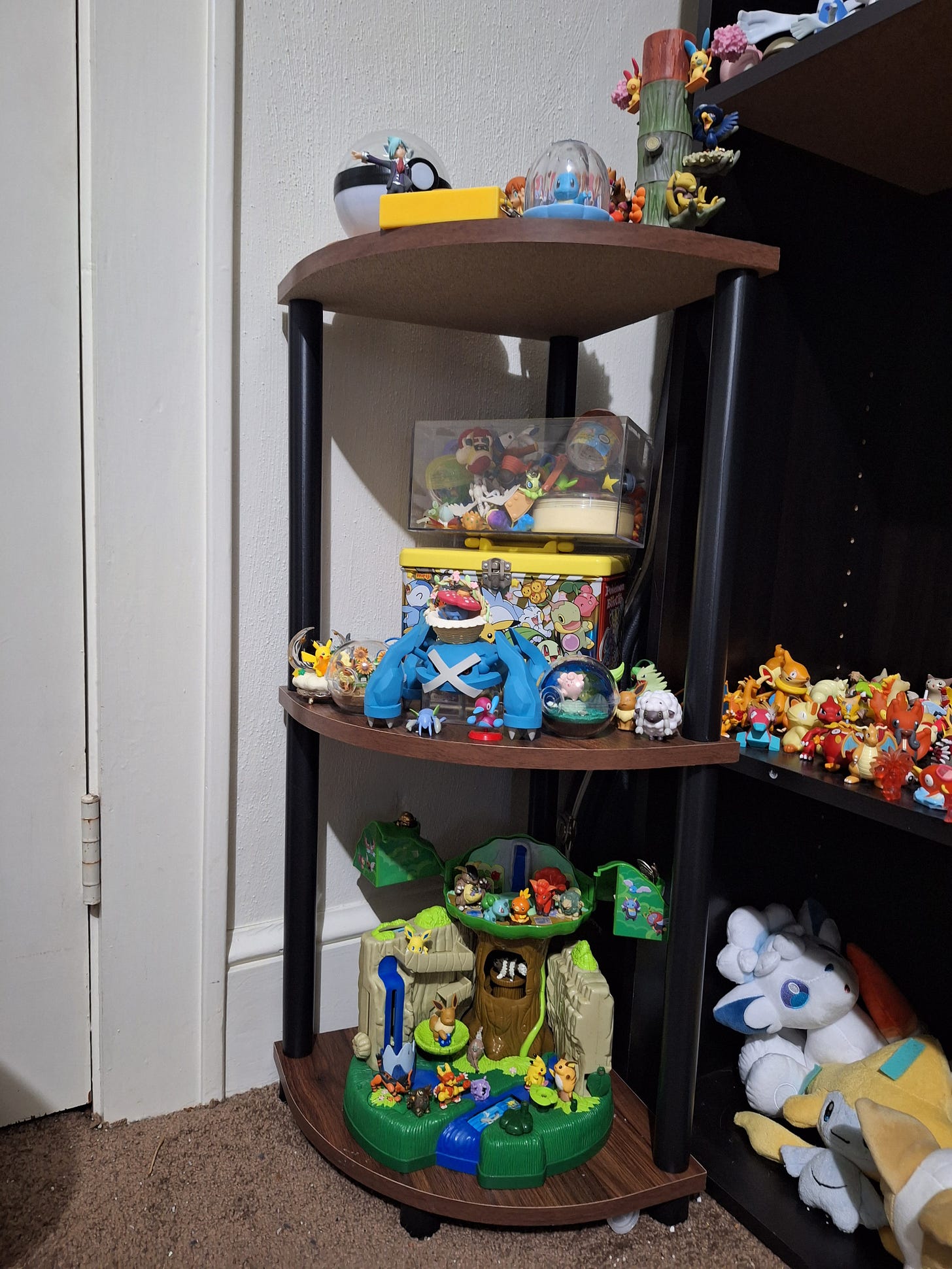 Miles has a smaller shelf filled with figures, such as a large Metagross figure, and a world scale figure of Steven from Pokémon Ruby & Sapphire! Miles has a smaller shelf filled with figures, such as a large Metagross figure, and a world scale figure of Steven from Pokémon Ruby & Sapphire!