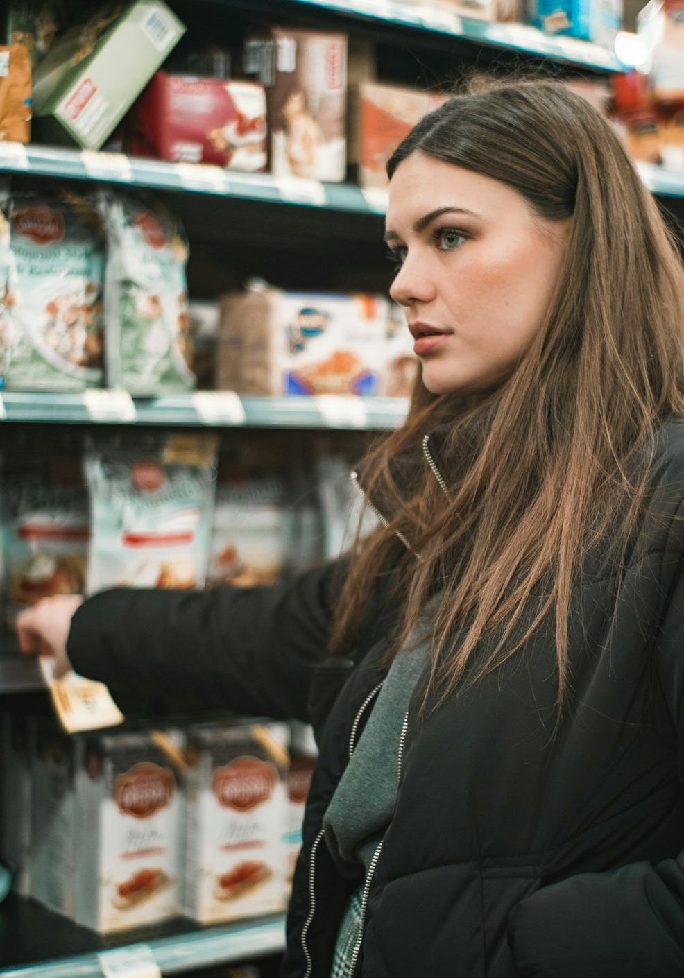 woman standing infront of shelf
