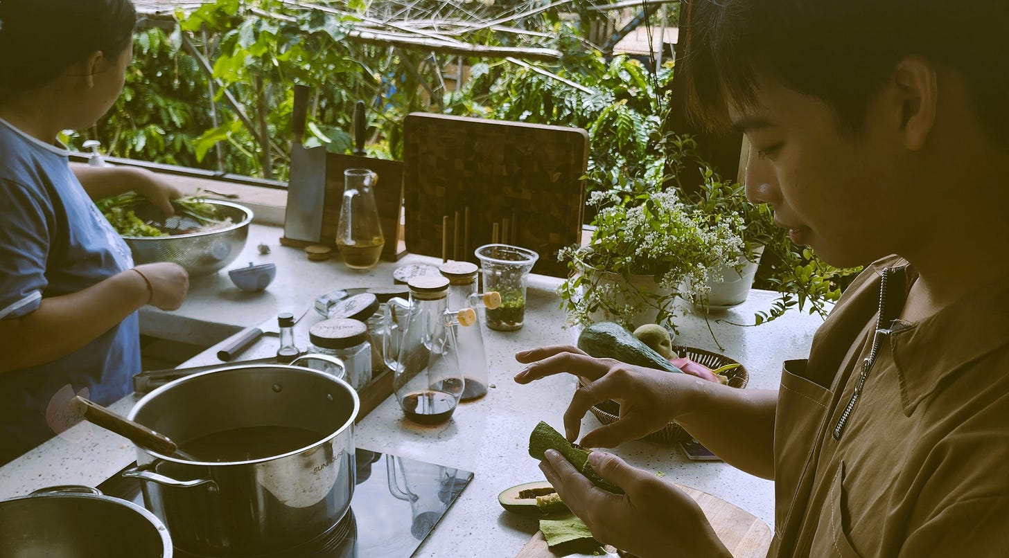Two people slicing vegetables in an open-air kitchen, their hands moving in action as they prepare a meal. Two people slicing vegetables in an open-air kitchen, their hands moving in action as they prepare a meal.