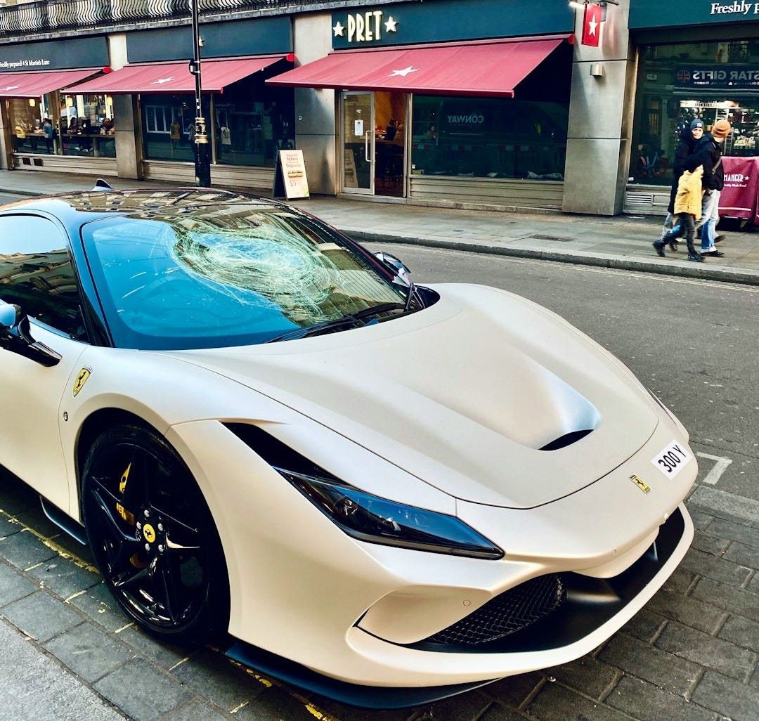 a white sports car parked on the side of the road a white sports car parked on the side of the road