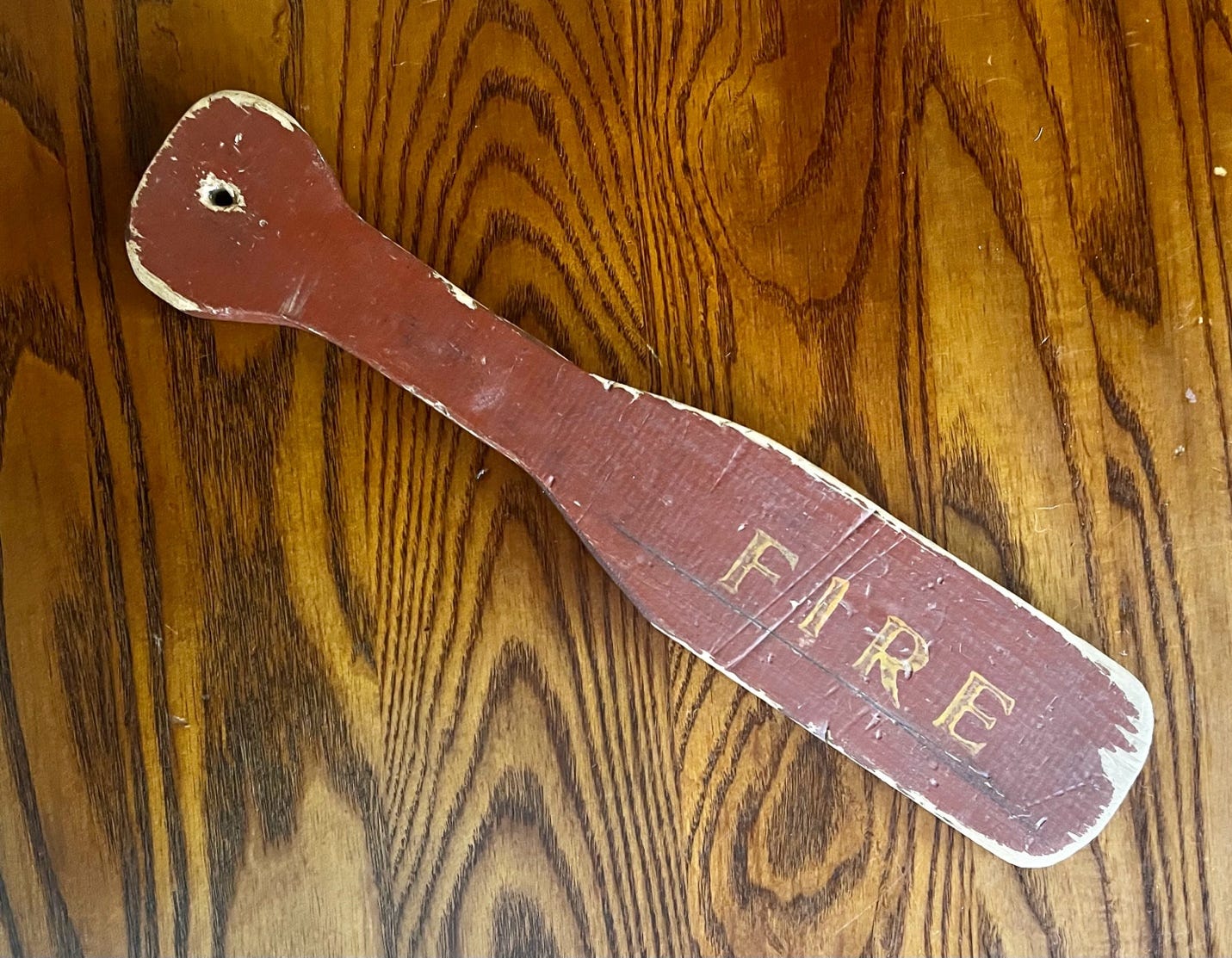 A wooden paddle on a wood surface

AI-generated content may be incorrect.