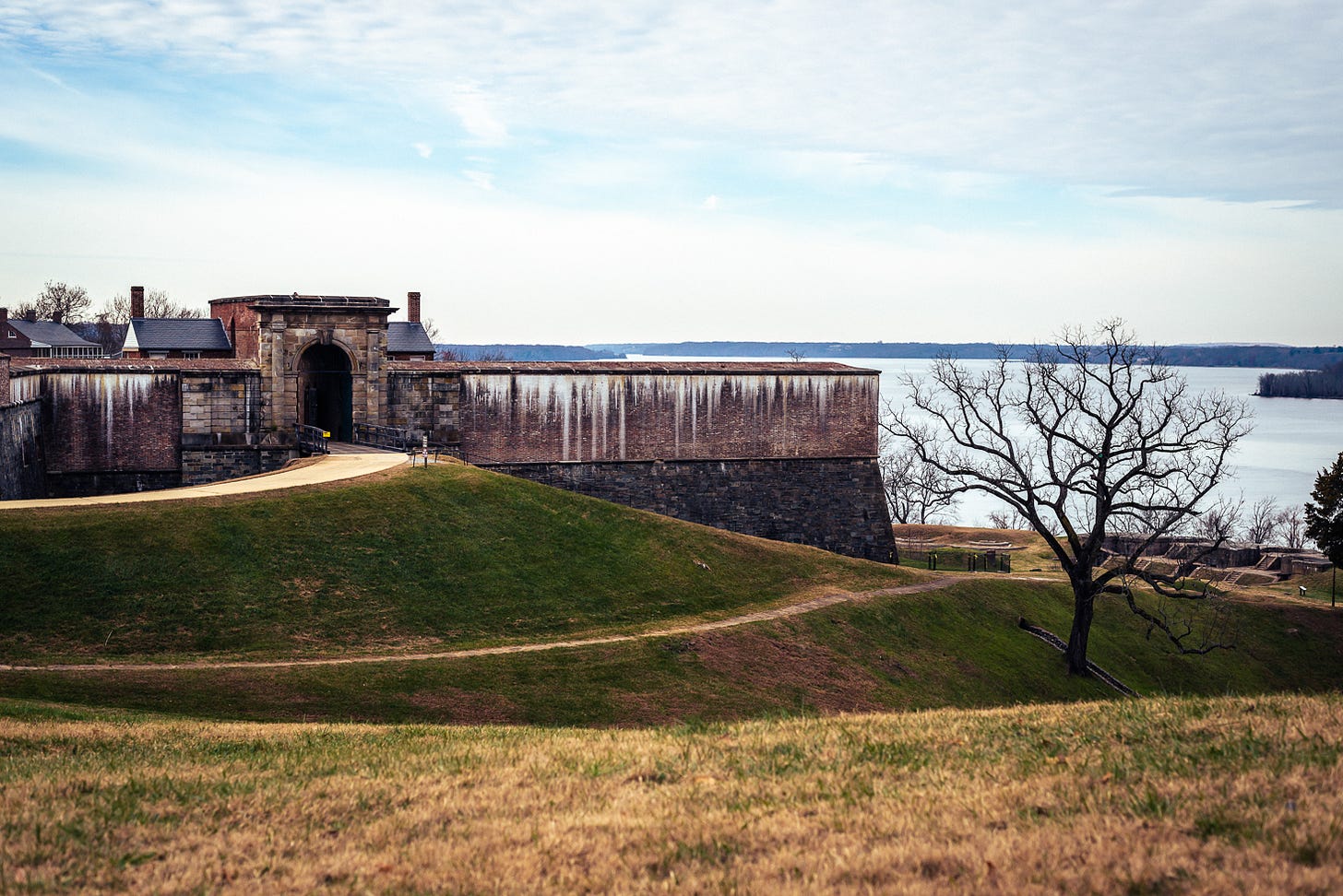 An old stone fort on a high overlooking water. 
