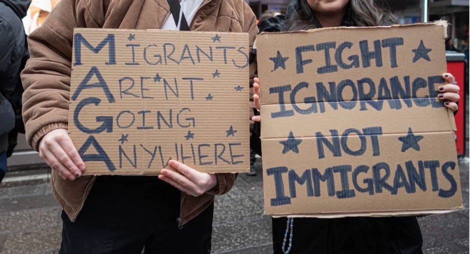 A group of people holding signs

AI-generated content may be incorrect.