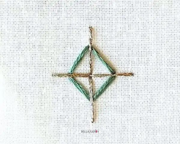 finished accent stitch with a sage diamond and gold metallic thread in the form of a cross