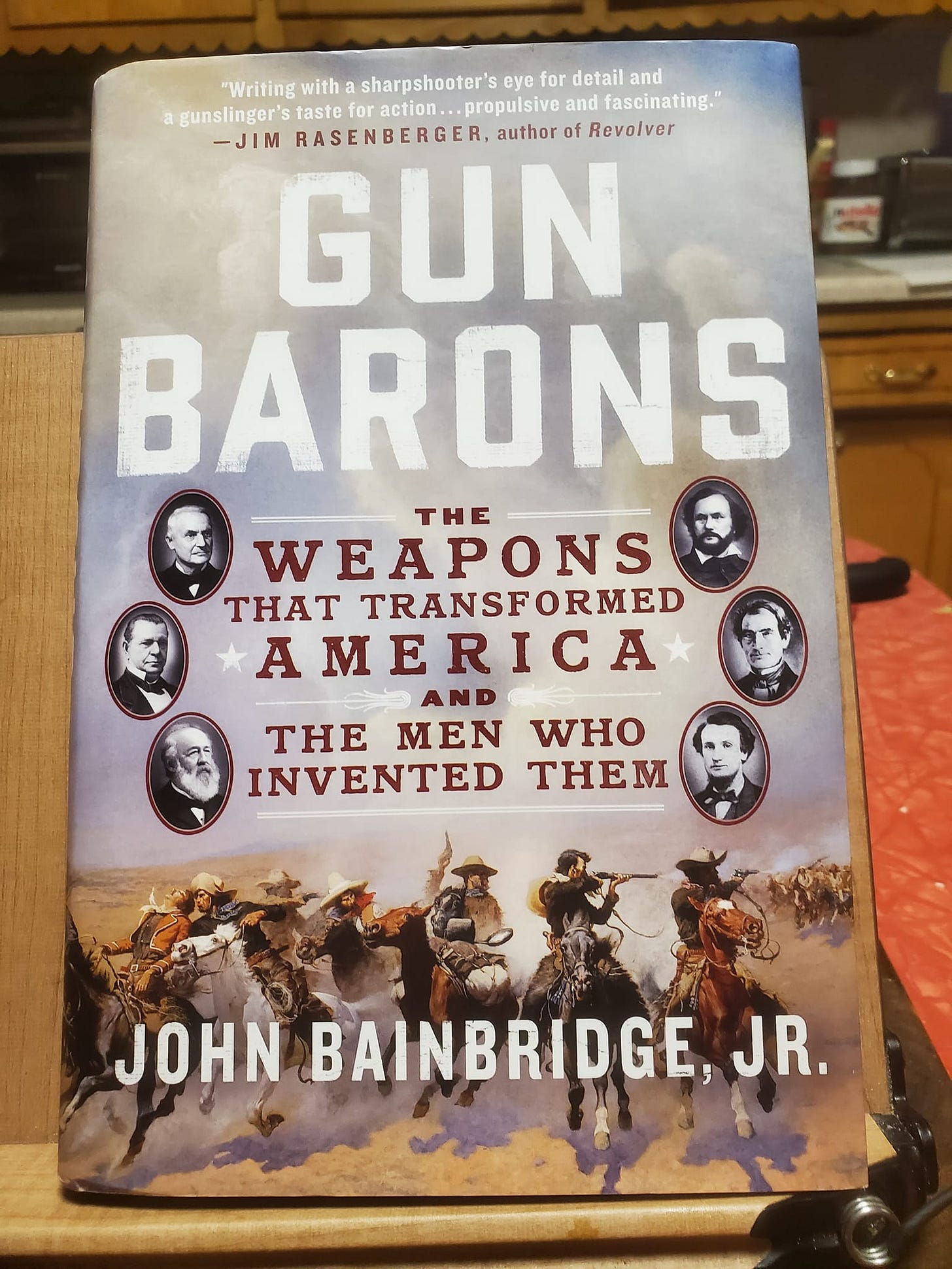 May be an image of text that says '"Writing with a sharpshooter's oye for detail and gunslinger's aste for action propulsive and fascinating." -JIM RASENBERGER author of Revolver GUN BARONS THE WEAPONS THAT TRANSFORMED A AMERICA THE MEN WHO INVENTED THEM JOHN BAINBRIDGE, JR.'