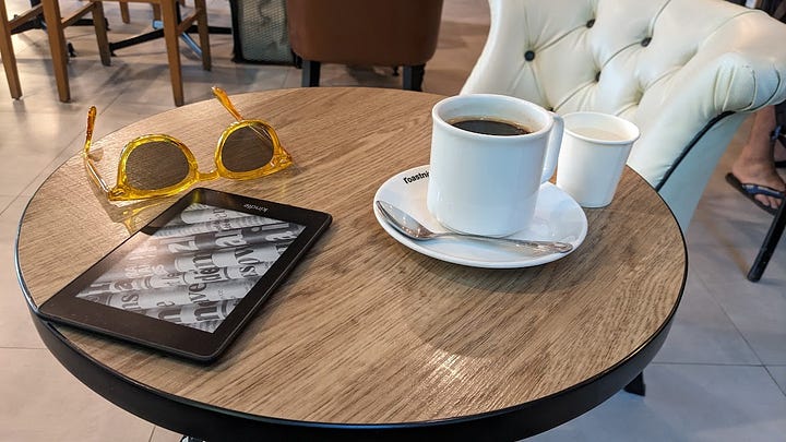 scene of a white mug of coffee, scene of a crossword puzzle and cold Thai beer