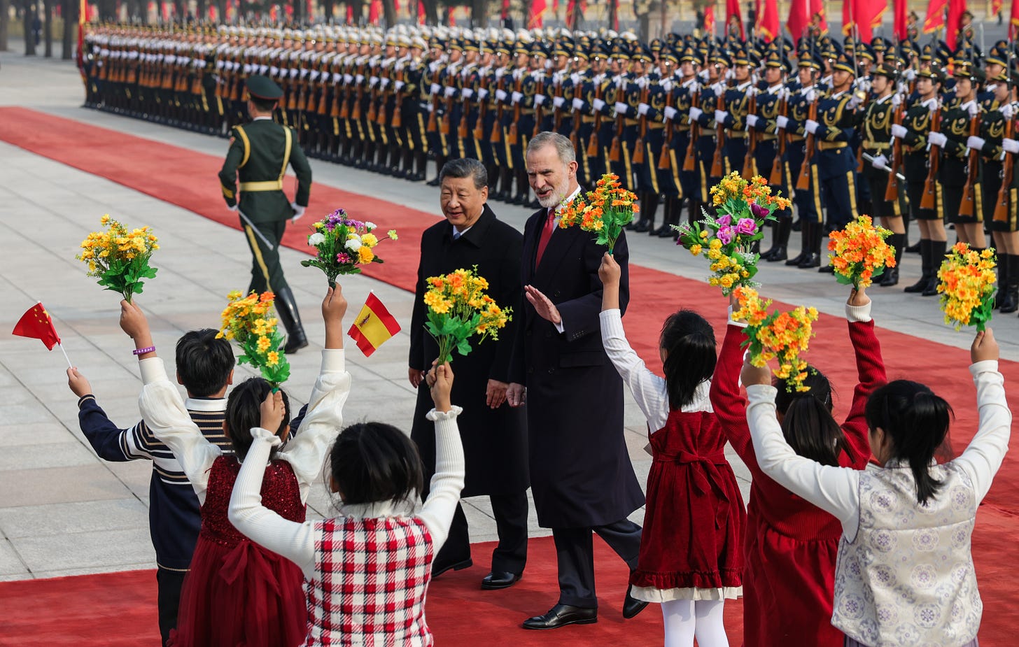 King Felipe VI of Spain and Chinese President Xi Jinping waving to children King Felipe VI of Spain and Chinese President Xi Jinping waving to children