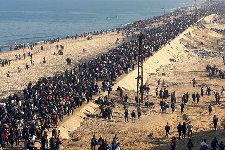 Palestinians walk back to their homes in northern Gaza. Palestinians walk back to their homes in northern Gaza.