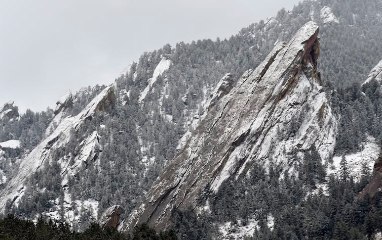 Snow sits on steep rocky slopes. Snow sits on steep rocky slopes.
