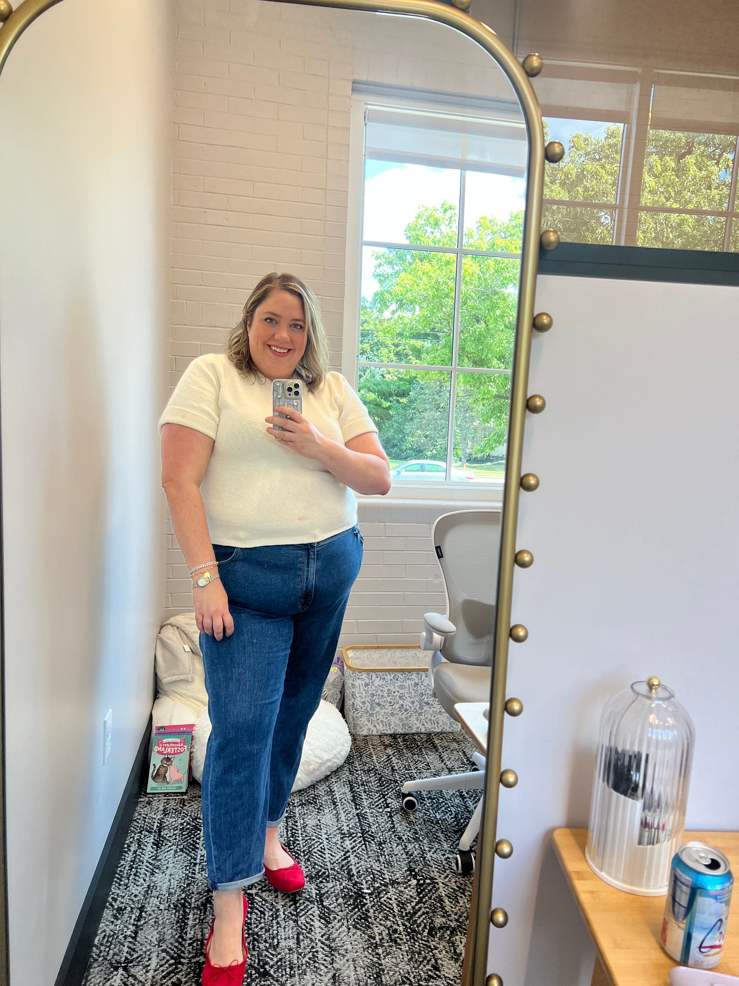 Picture of Sarah in a mirror in her new office.