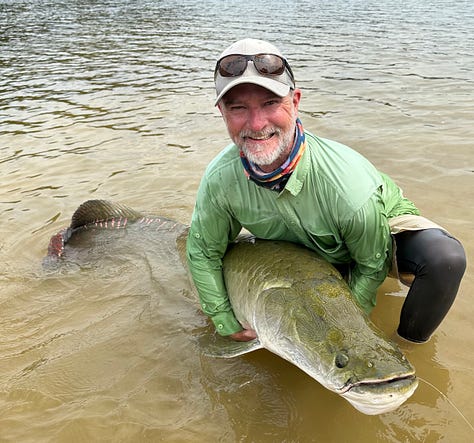 angler with large permit standing in the water