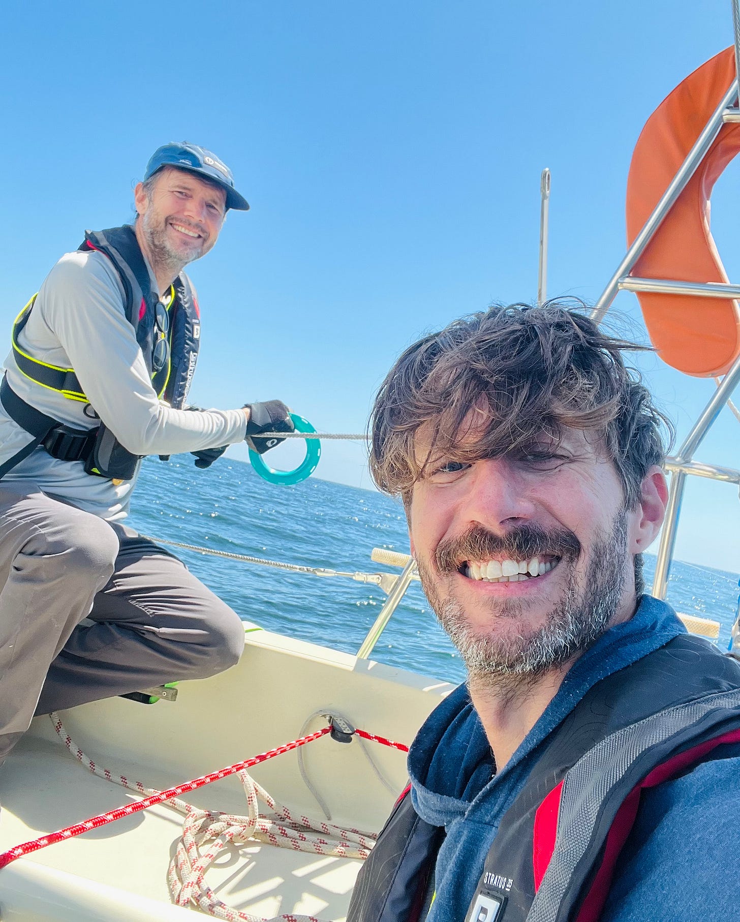Photo of author and husband on their sailboat at sea