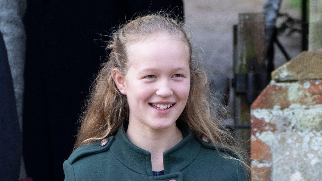 Girl in green coat smiling