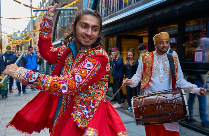 Free and cheap things to do in London: dancers and drummers taking part in the Bollywood Mela in Camden Market
