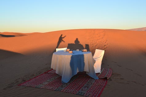 Moments from Dar Ahlam showing the thoughtful hospitality experience - the kasbah grounds, intimate dining spaces, desert excursions, and candlelit dinners that exemplified genuine welcome.