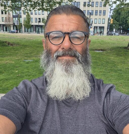 man in glasses and beard taking selfie