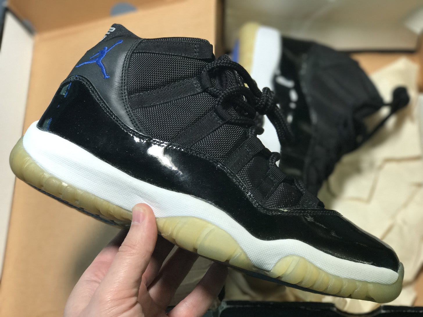 Nick Engvall holding his own pair of black and royal Air Jordan 11 Space Jam sneakers Nick Engvall holding his own pair of black and royal Air Jordan 11 Space Jam sneakers