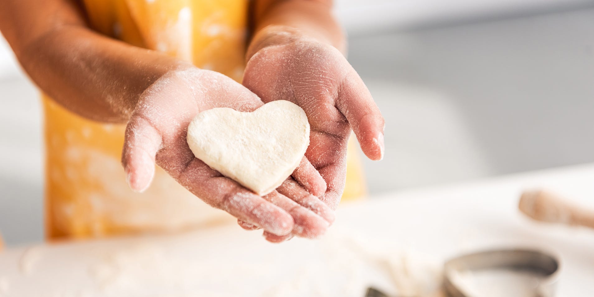 Baker serving up heart cookie representing writers putting themselves out there.