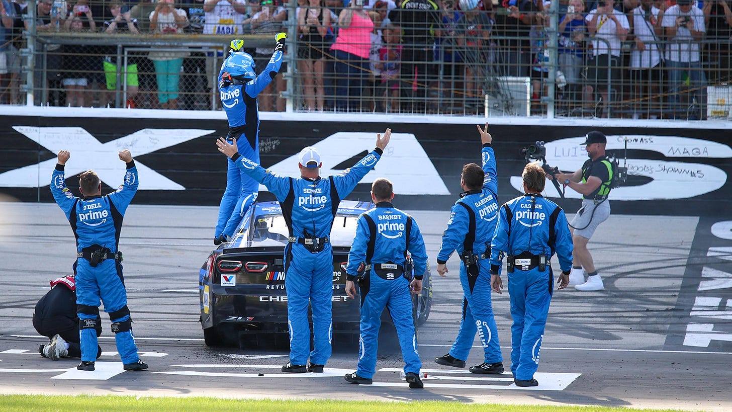 Chase Elliott celebrates with his team in front of the crowd after winning the Wurth 400 at Texas Motor Speedway.