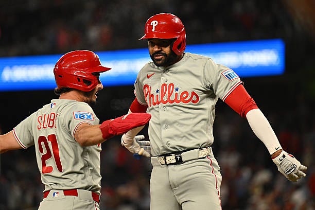 Derek Hill of the Philadelphia Phillies celebrates with Garrett Stubbs at home plate after hitting a two-run home run in the ninth inning against the...