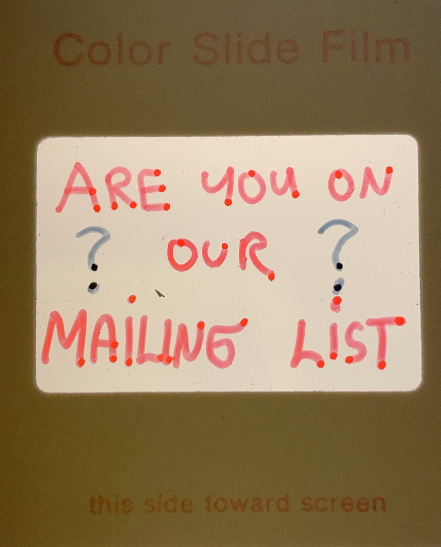 scan of a 35mm slide that is hand written and says are you on our mailing list?