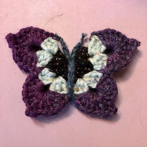 Nine multi-coloured crocheted butterflies