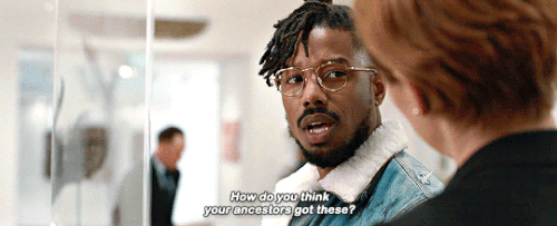 Gif from the Black Panter movie, showing Killmonger (played by Michael B. Jordan) at the British Museum. Asking a docent (white woman) "How do you think your ancestors get these?"