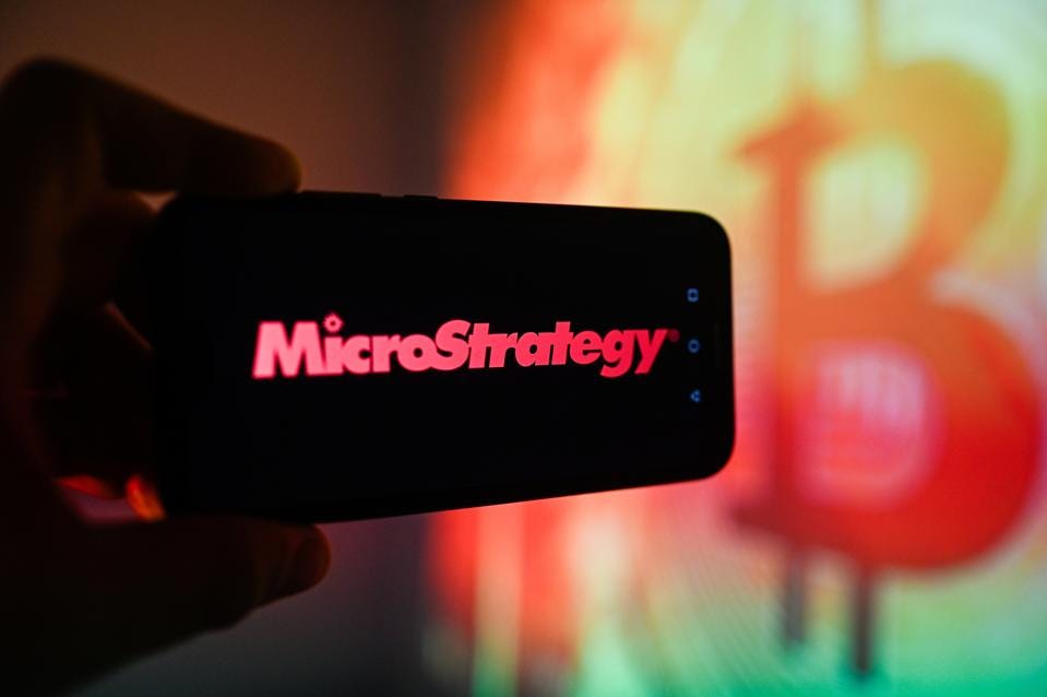 In this photo illustration a Micro Strategy logo is In this photo illustration a Micro Strategy logo is