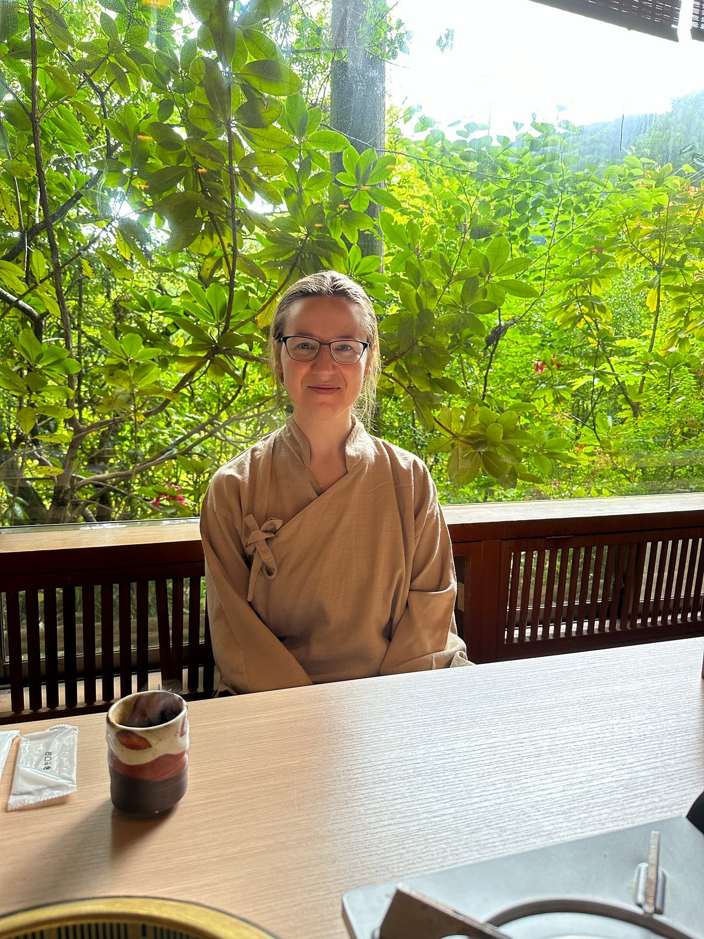Mari-Alina Timoshchuk at a Japanese table in a traditional Japanese inn