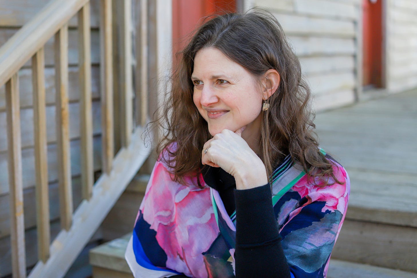 Catherine sitting on steps with hand on chin