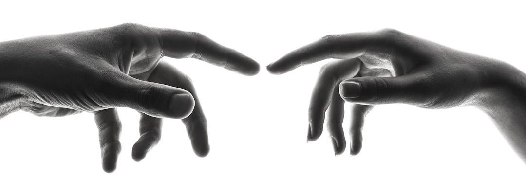 two person's connecting fingers