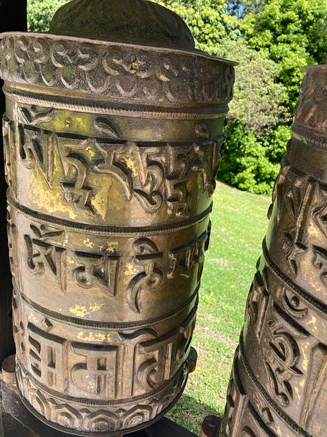 Six photos of an Asian temple, gardens, bamboo, buddha and prayer wheels.