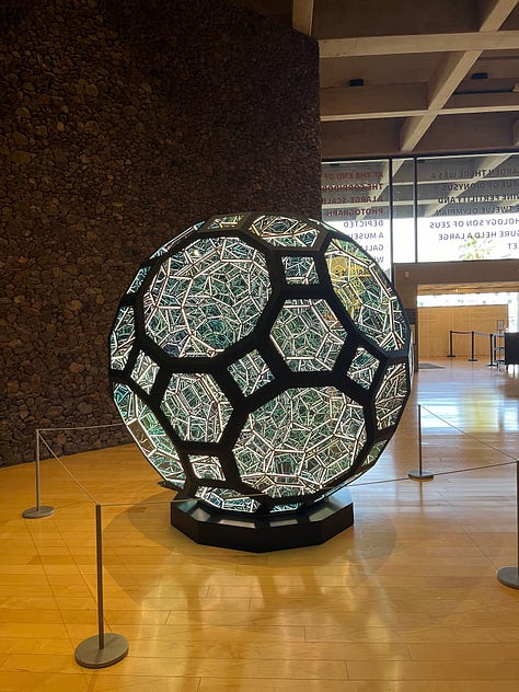 Anthony James , "80" Great Rhombicosidodecahedron," 2021 (left), To Move Toward the Limits of Living: LGBTQ+ Works from the Collection (center), Karen LaMonte, Pianist's Dress Impression, 2005 (right)