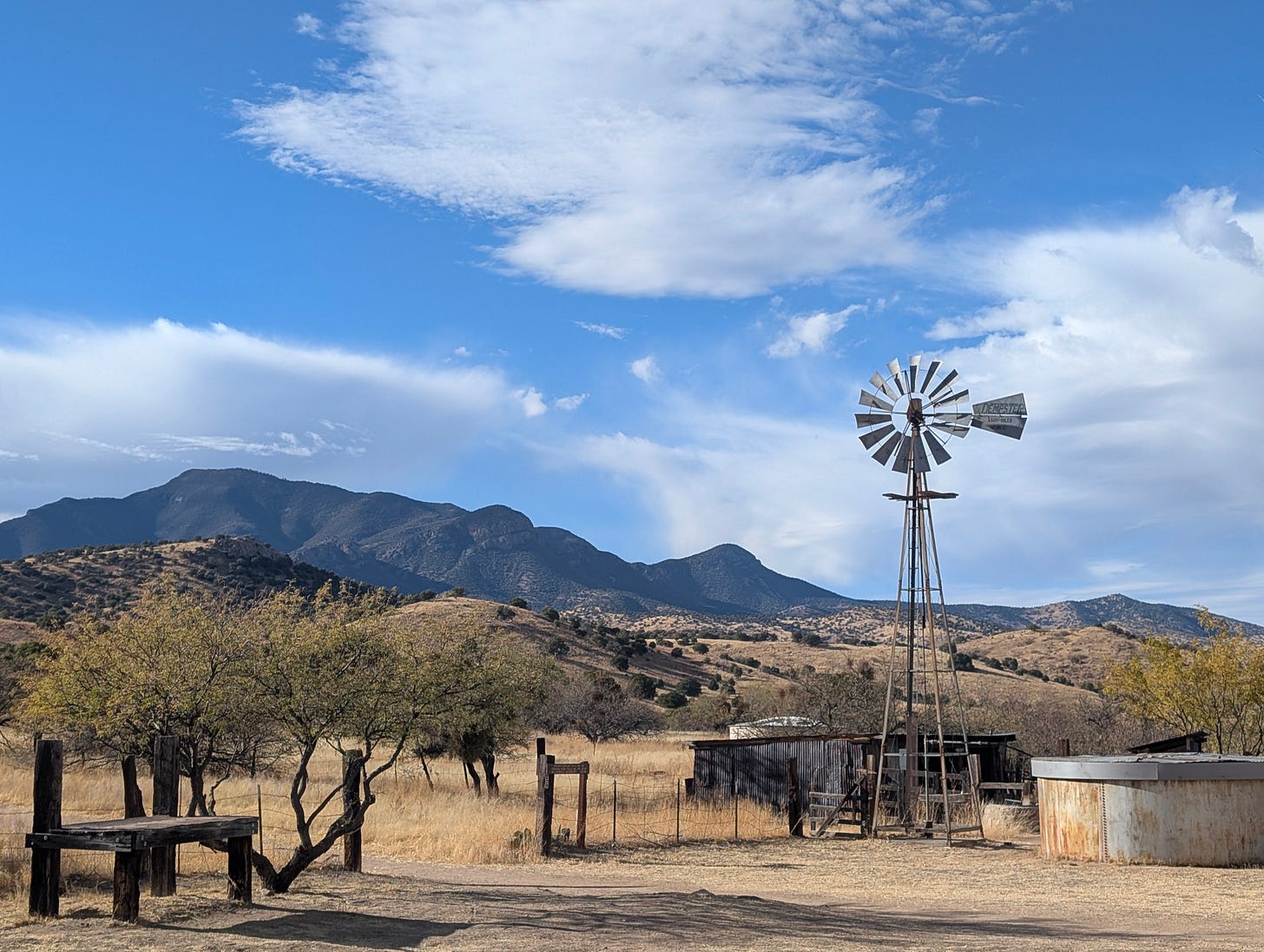 Windmill with mountains and clouds in the background