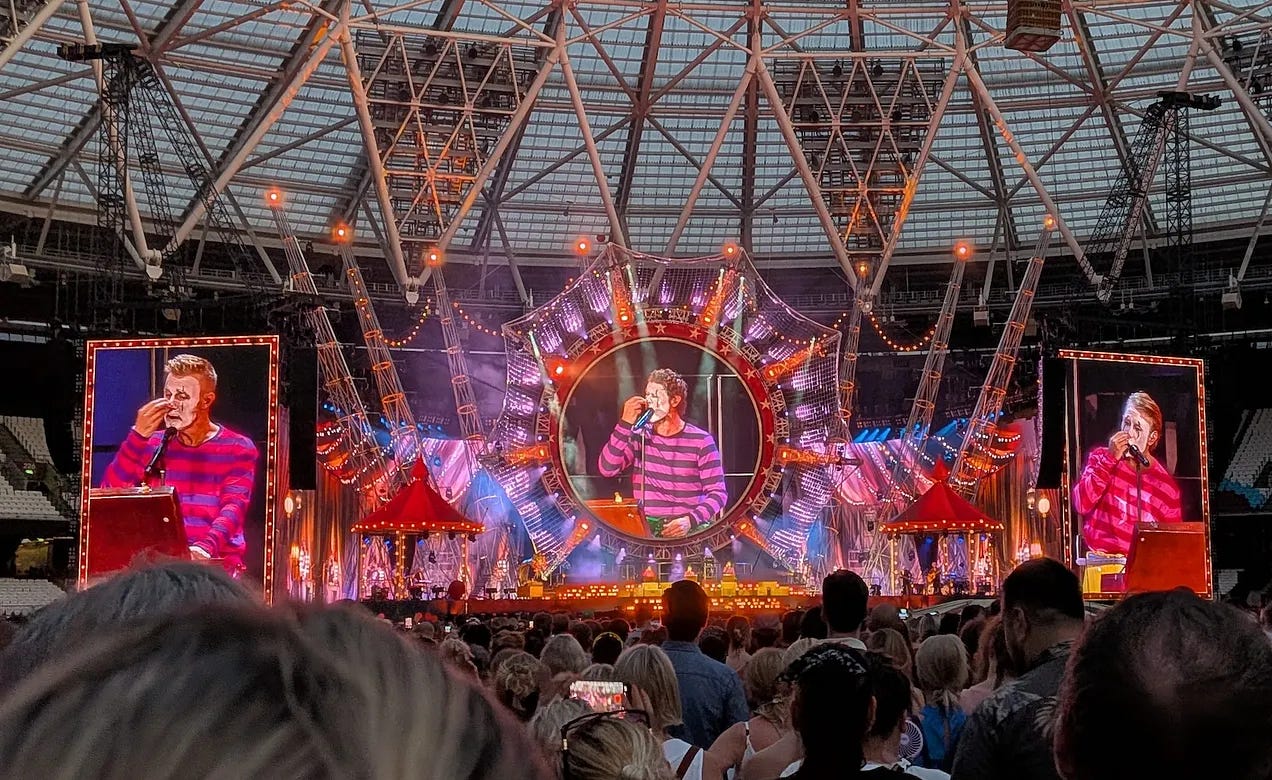 Take That putting on clown makeup as part of their Circus concert performance