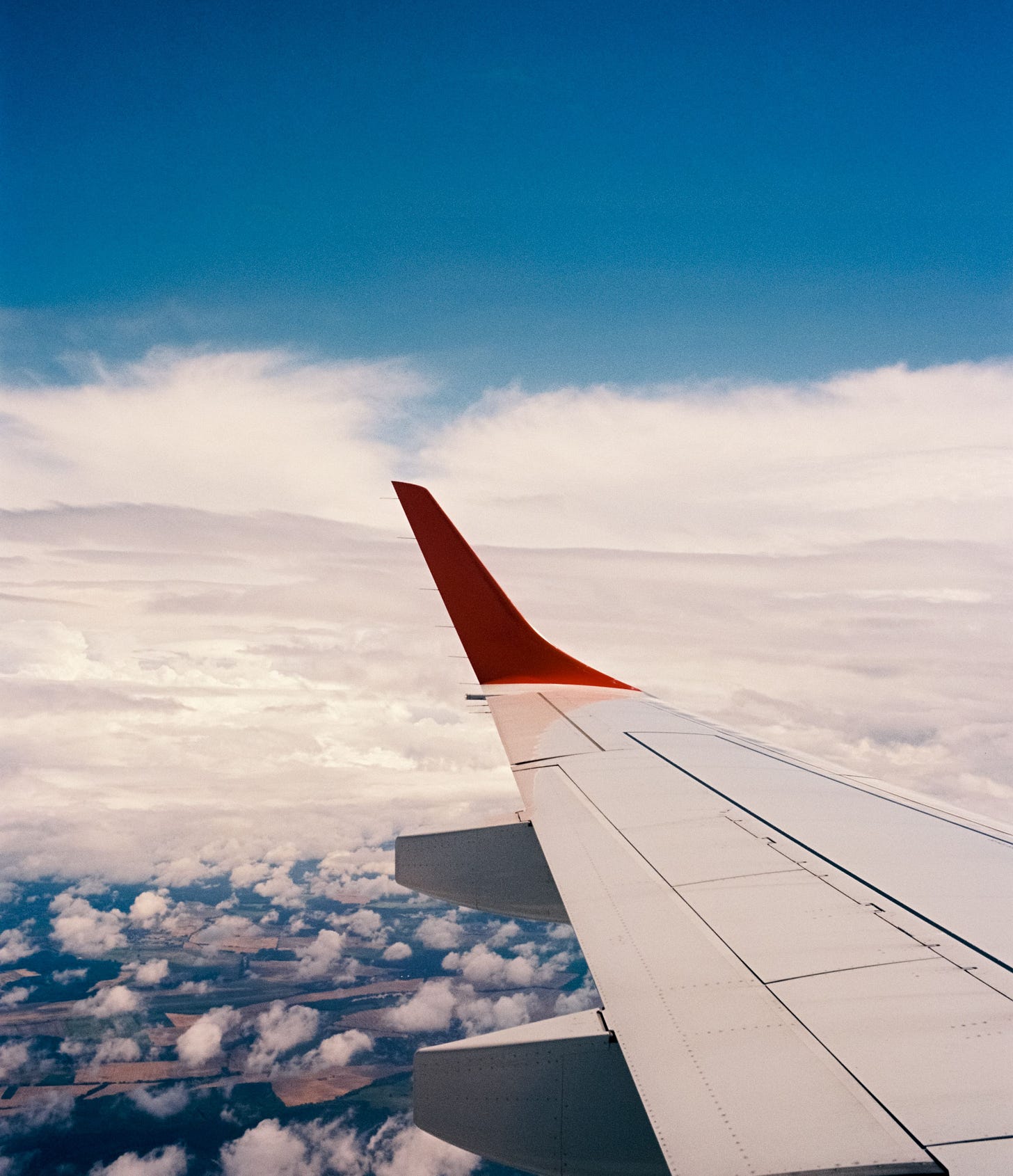 Scenic view from an airplane window, showcasing the wing and a vast sky filled with clouds Edgewalkers Collective Kay Fabella The Invisible Labor of Self-Translation in Life Abroad Scenic view from an airplane window, showcasing the wing and a vast sky filled with clouds Edgewalkers Collective Kay Fabella The Invisible Labor of Self-Translation in Life Abroad