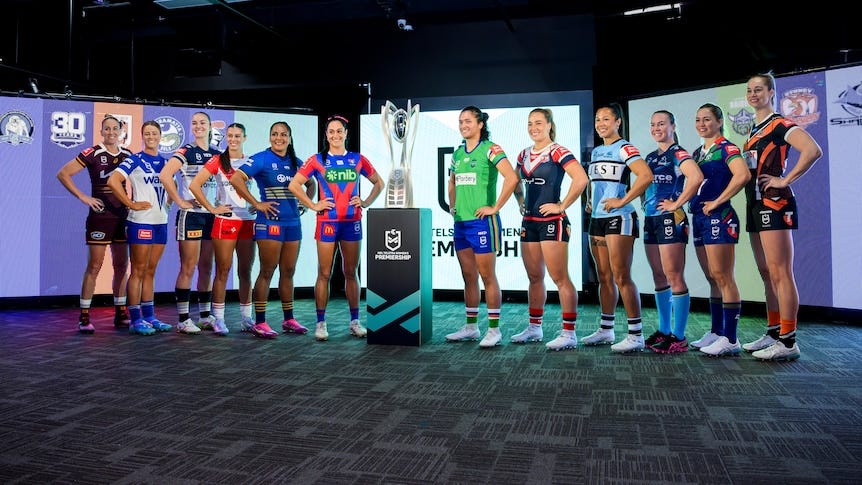 A group of rugby league captains assemble before a trophy 