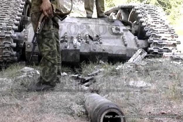 An upside T-55AM main battle tank with its turret buried, belonging to the Georgian Armed Forces during the War in Abkhazia and Georgian Civil War, circa August 1992 - September 1993.