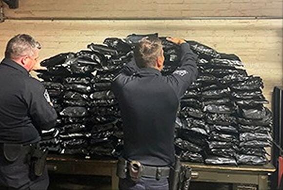 CBP Officers stack bundles of confiscated pot