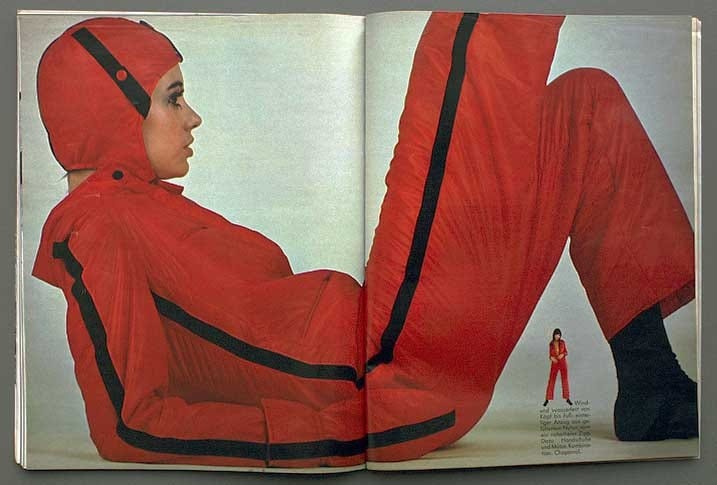 This may contain: an open magazine with a woman in red on the cover