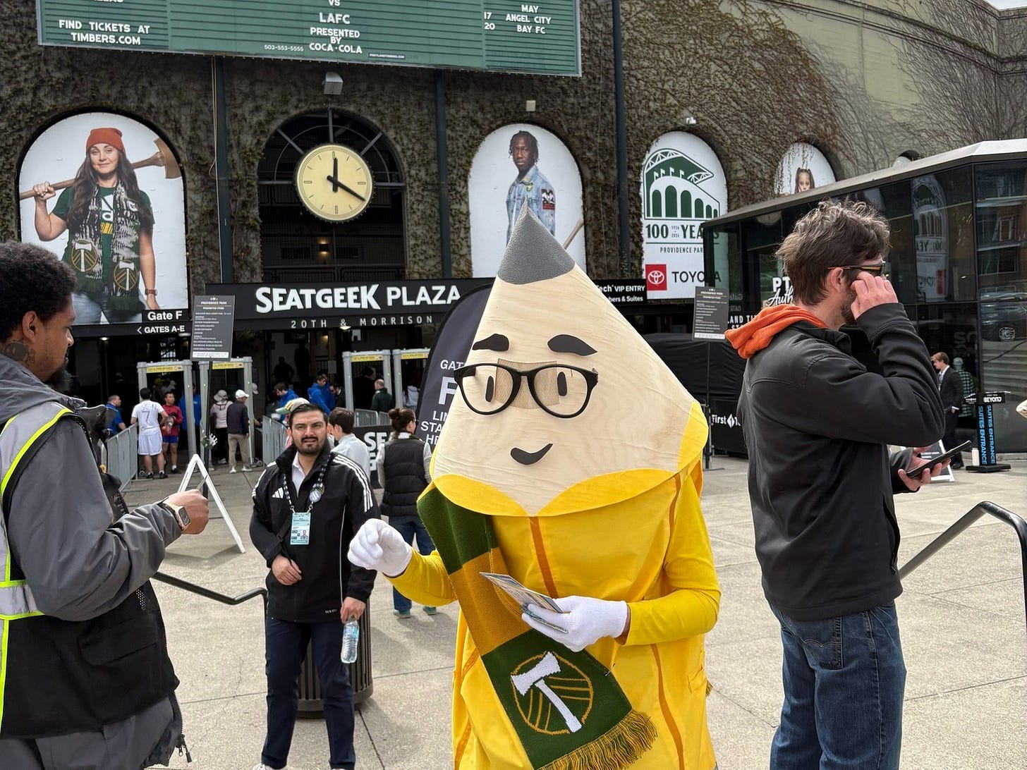 A person dressed as a pencil in front of Providence Park, before a Timbers Match A person dressed as a pencil in front of Providence Park, before a Timbers Match