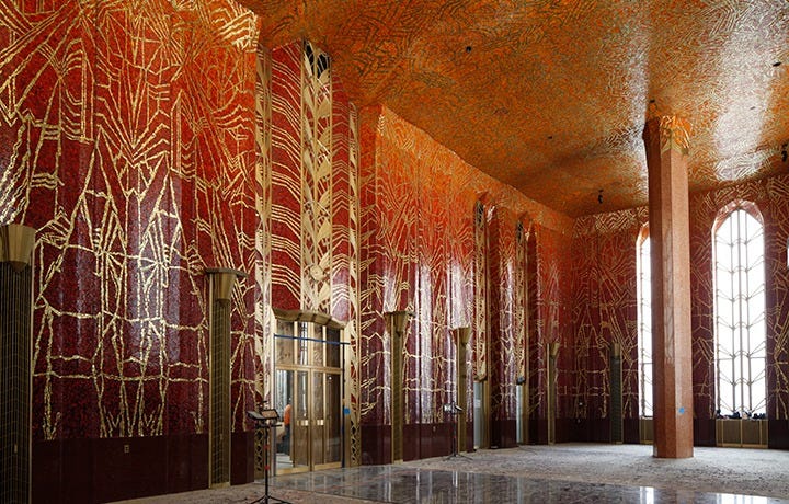 Red room with high ceilings and pillars, walls and ceiling covered with red mosaic tile with gold designs Red room with high ceilings and pillars, walls and ceiling covered with red mosaic tile with gold designs