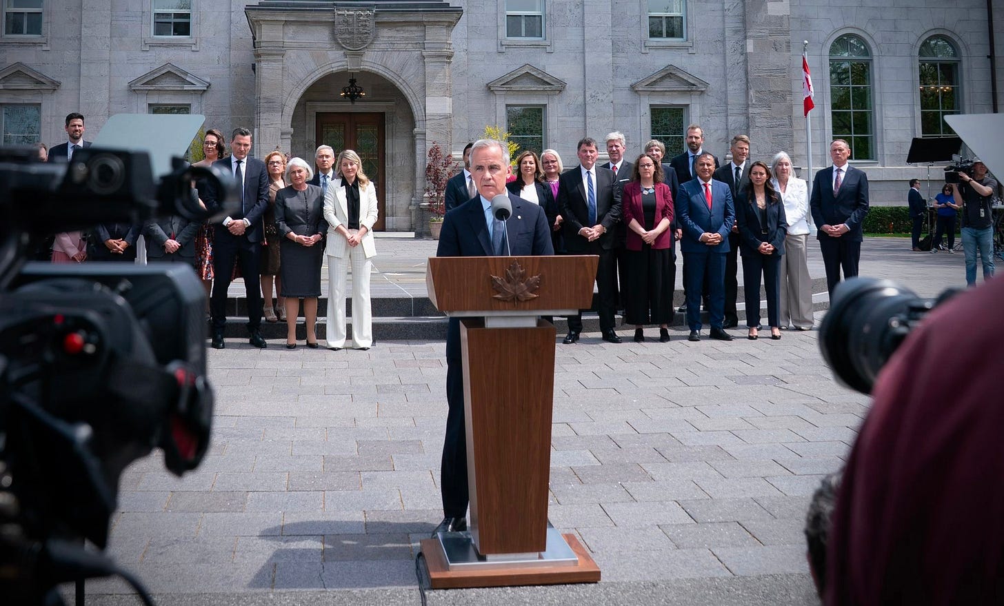 Prime Minister Carney holds a press conference standing in front of his Cabinet on May 13, 2025. Prime Minister Carney holds a press conference standing in front of his Cabinet on May 13, 2025.