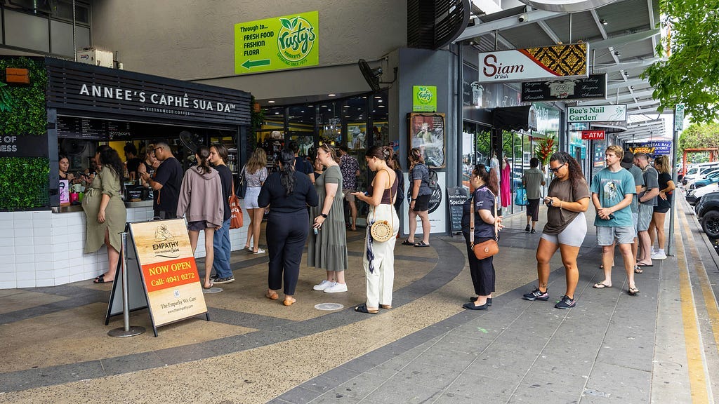 Group of people standing outside of a store