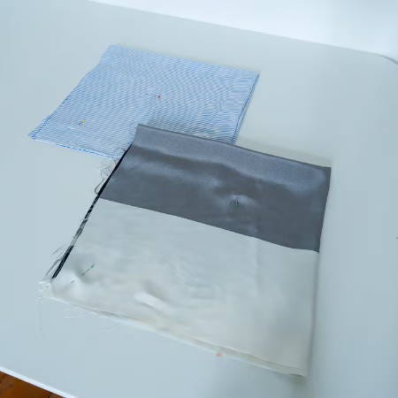 two folded square fabric pieces to cut a circle from two folded square fabric pieces to cut a circle from