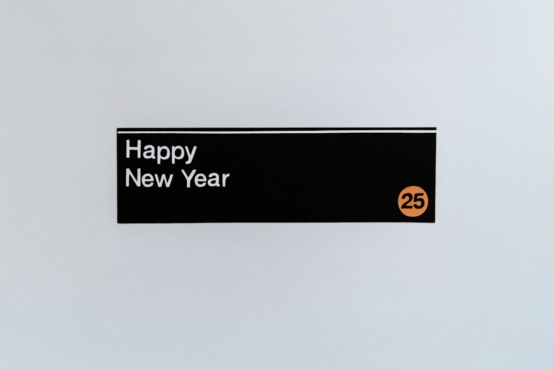 A sign that says happy new year hanging on a wall A sign that says happy new year hanging on a wall